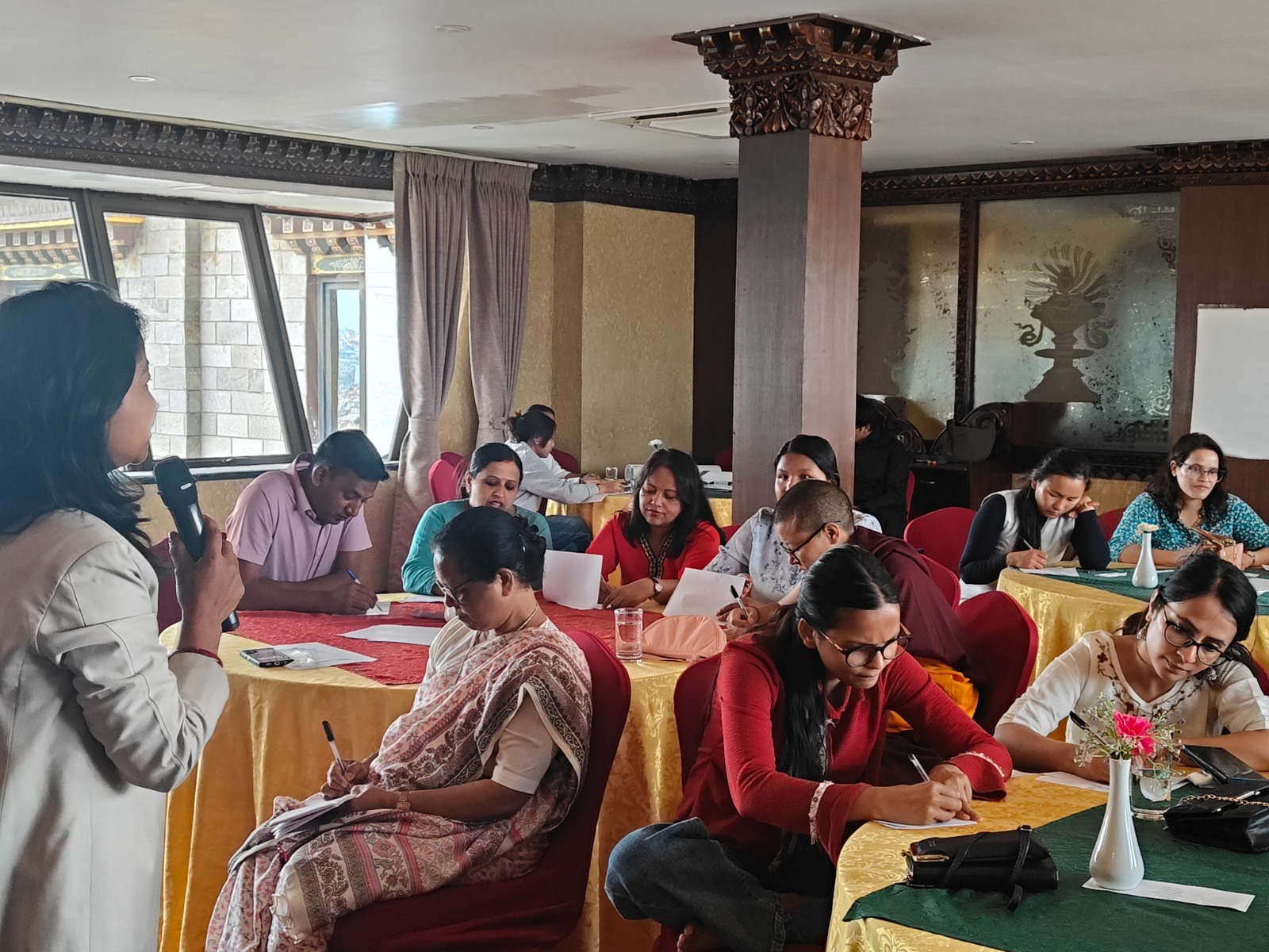Workshop participants taking notes at round tables