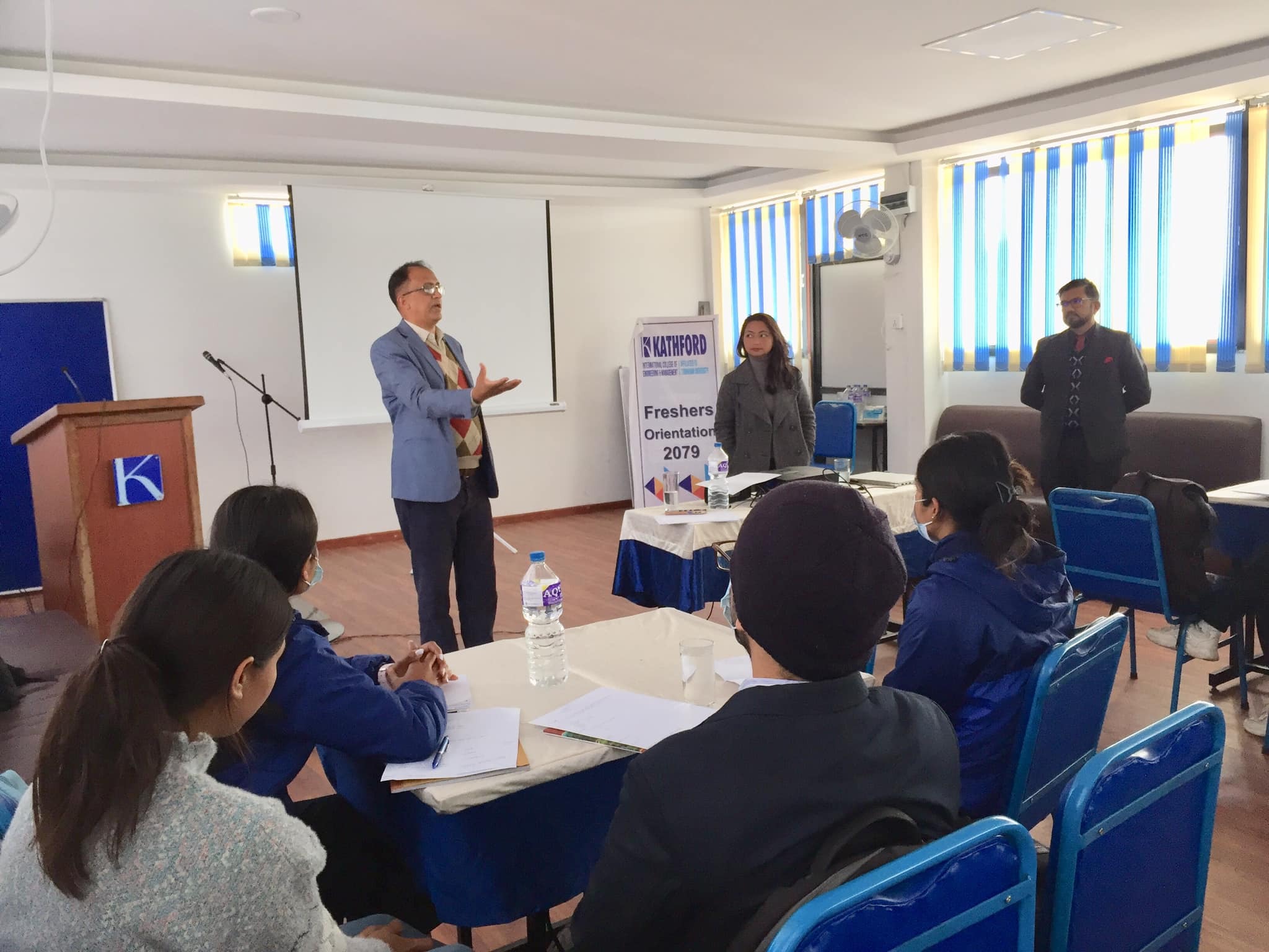 A facilitator addressing students at a college orientation